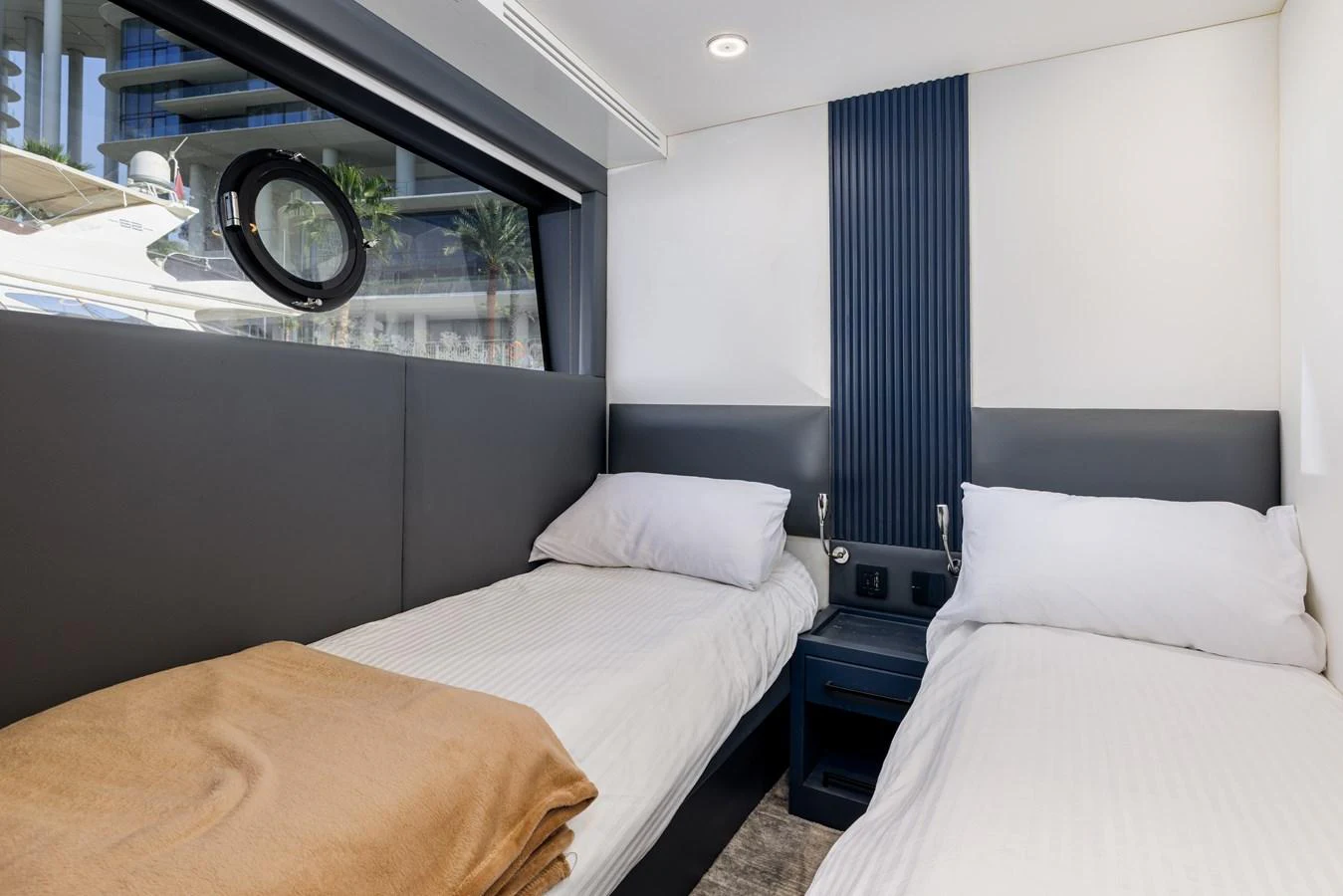 A cozy twin cabin with modern decor and ample natural light. aboard AL SULTAN Yacht for Sale
