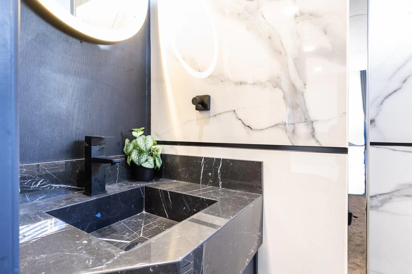 The yacht's bathroom features elegant marble surfaces and modern fixtures. aboard AL SULTAN Yacht for Sale