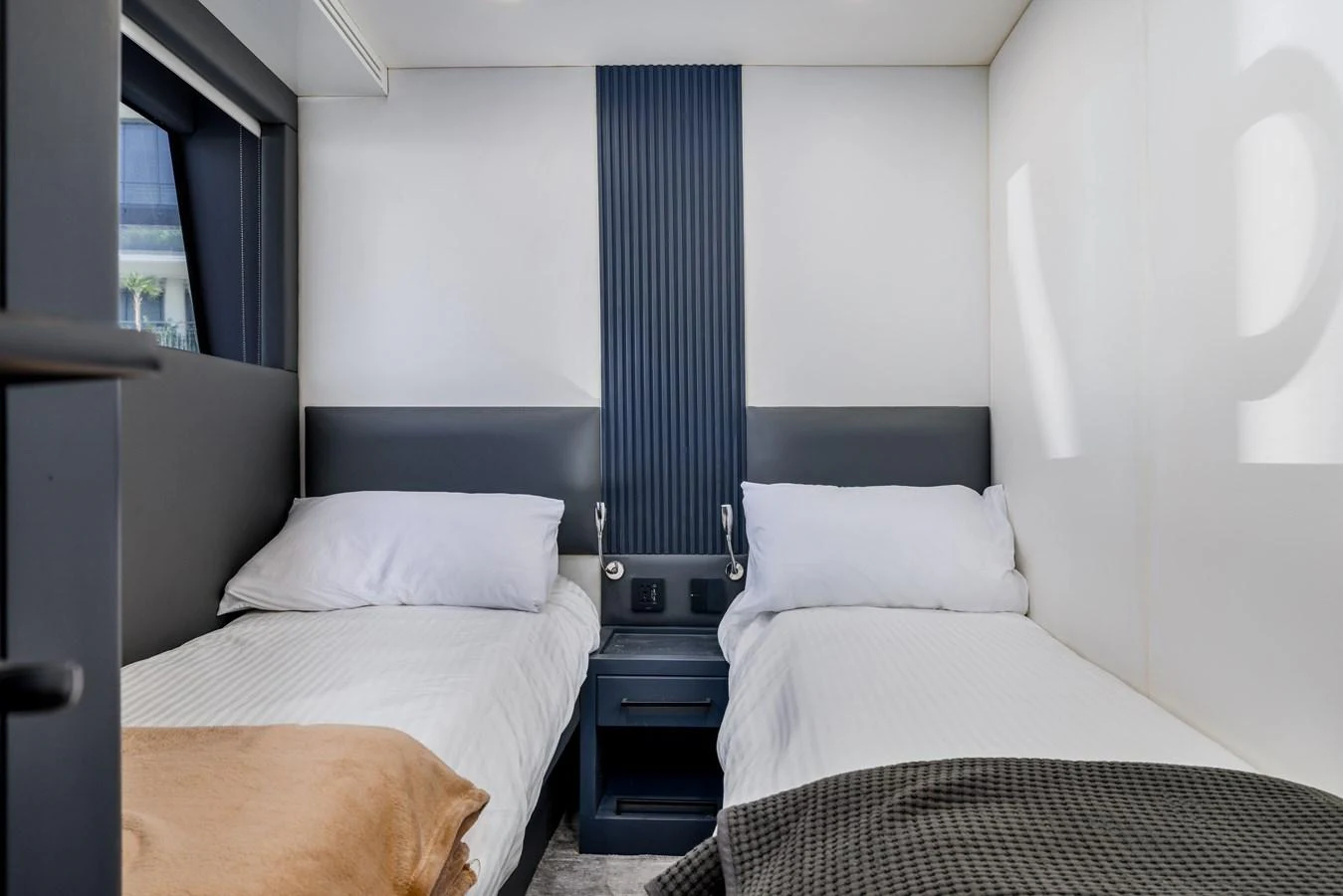 A cozy guest stateroom with twin beds and modern decor. aboard AL SULTAN Yacht for Sale