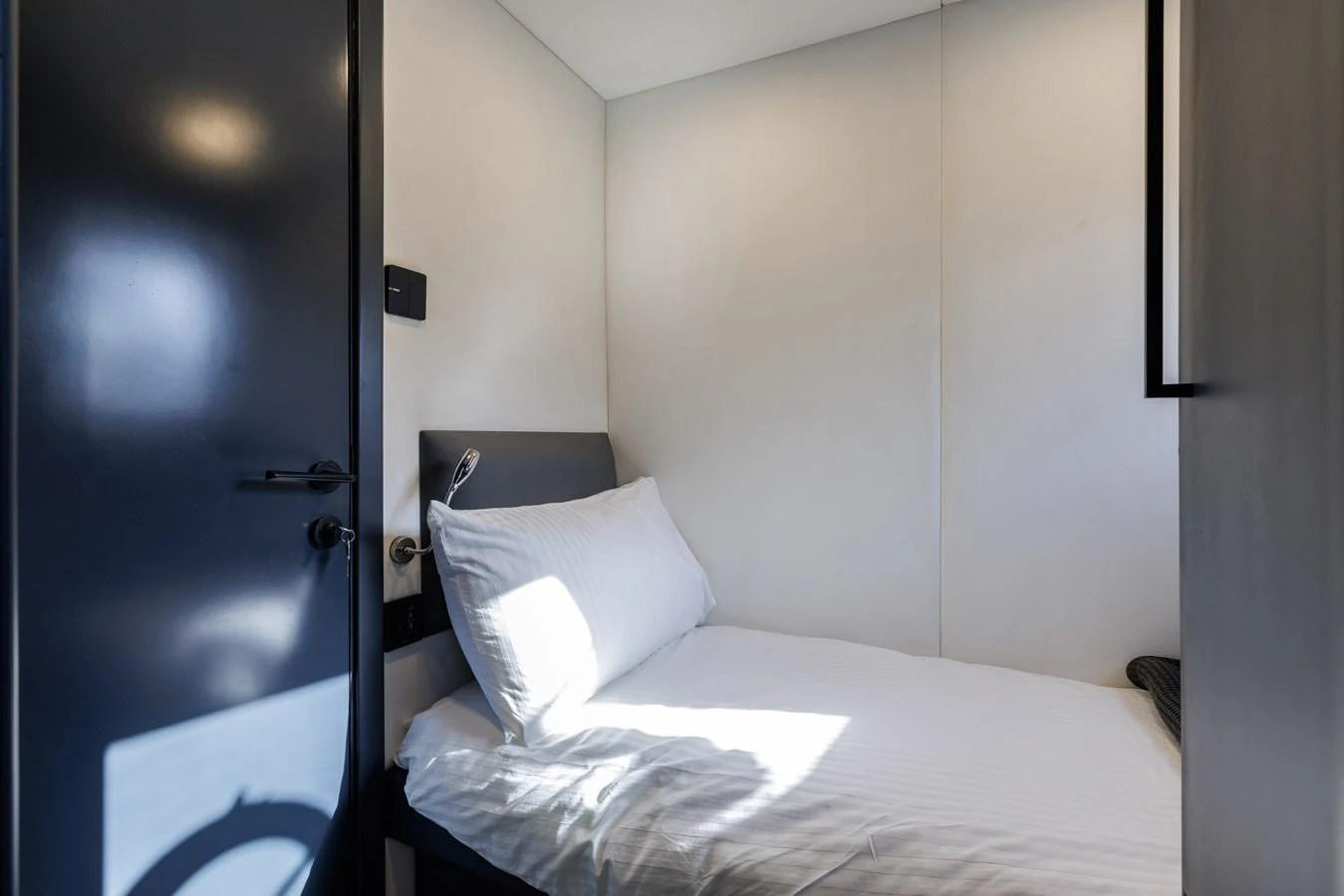 A cozy guest cabin featuring a comfortable bed with crisp white linens. aboard AL SULTAN Yacht for Sale