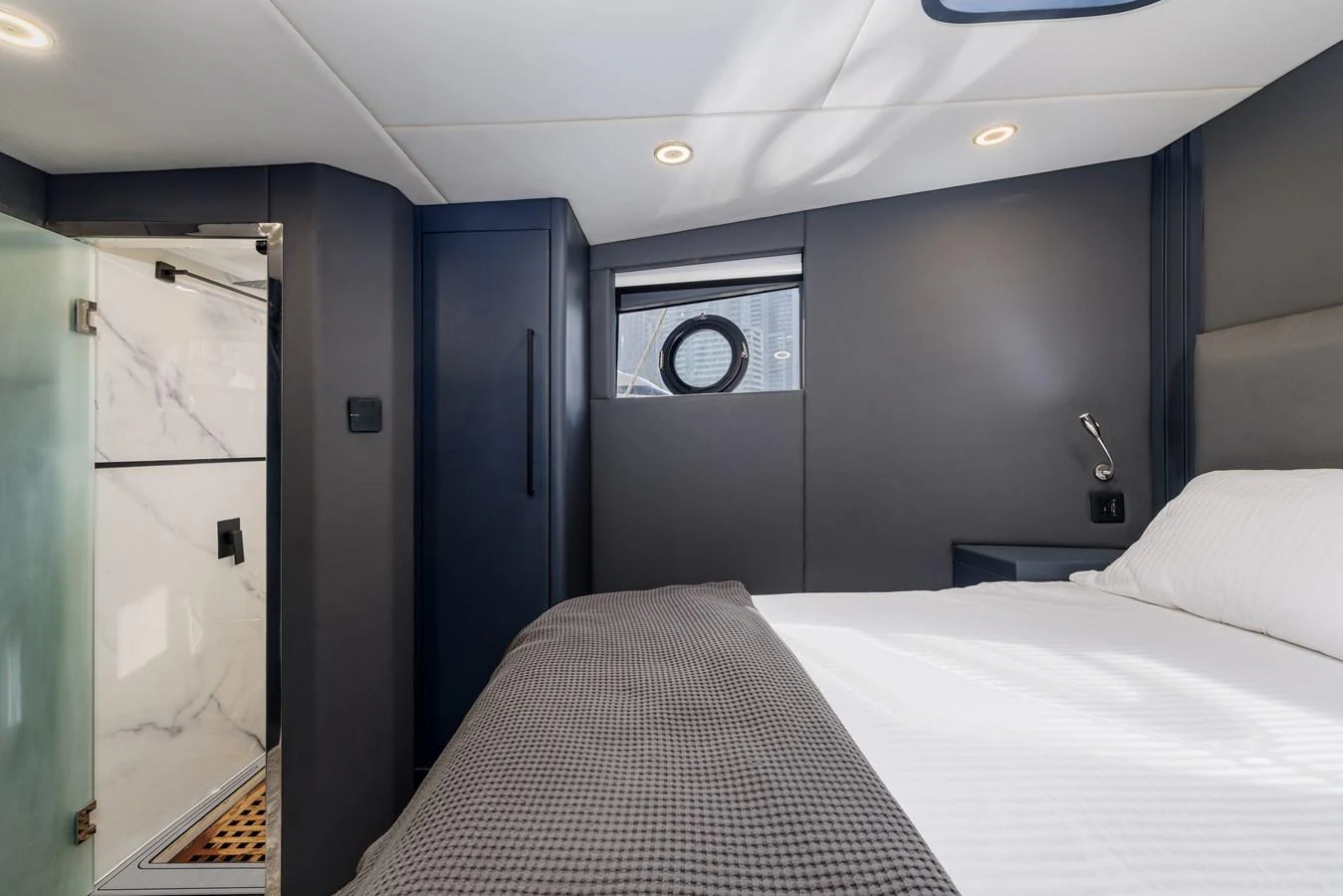 A cozy stateroom featuring a comfortable bed and an ensuite bathroom. aboard AL SULTAN Yacht for Sale