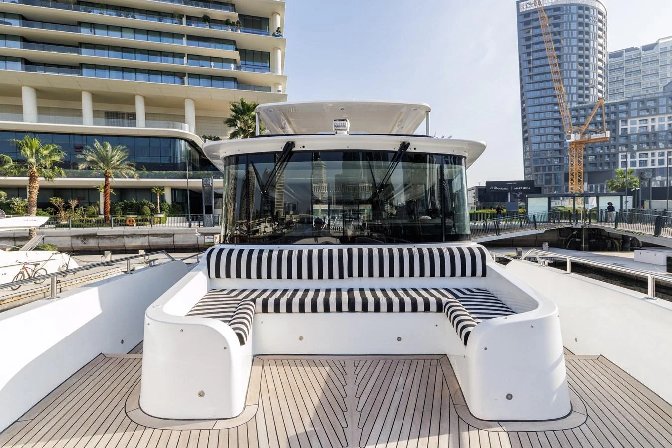 The foredeck features a stylish seating area with striped cushions, perfect for relaxation. aboard AL SULTAN Yacht for Sale