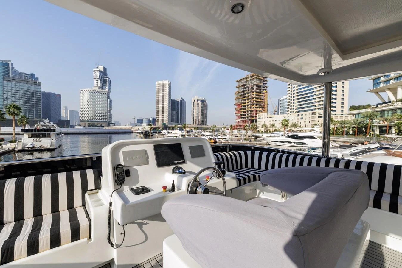 The yacht's helm offers a comfortable and stylish area with a view of the marina. aboard AL SULTAN Yacht for Sale