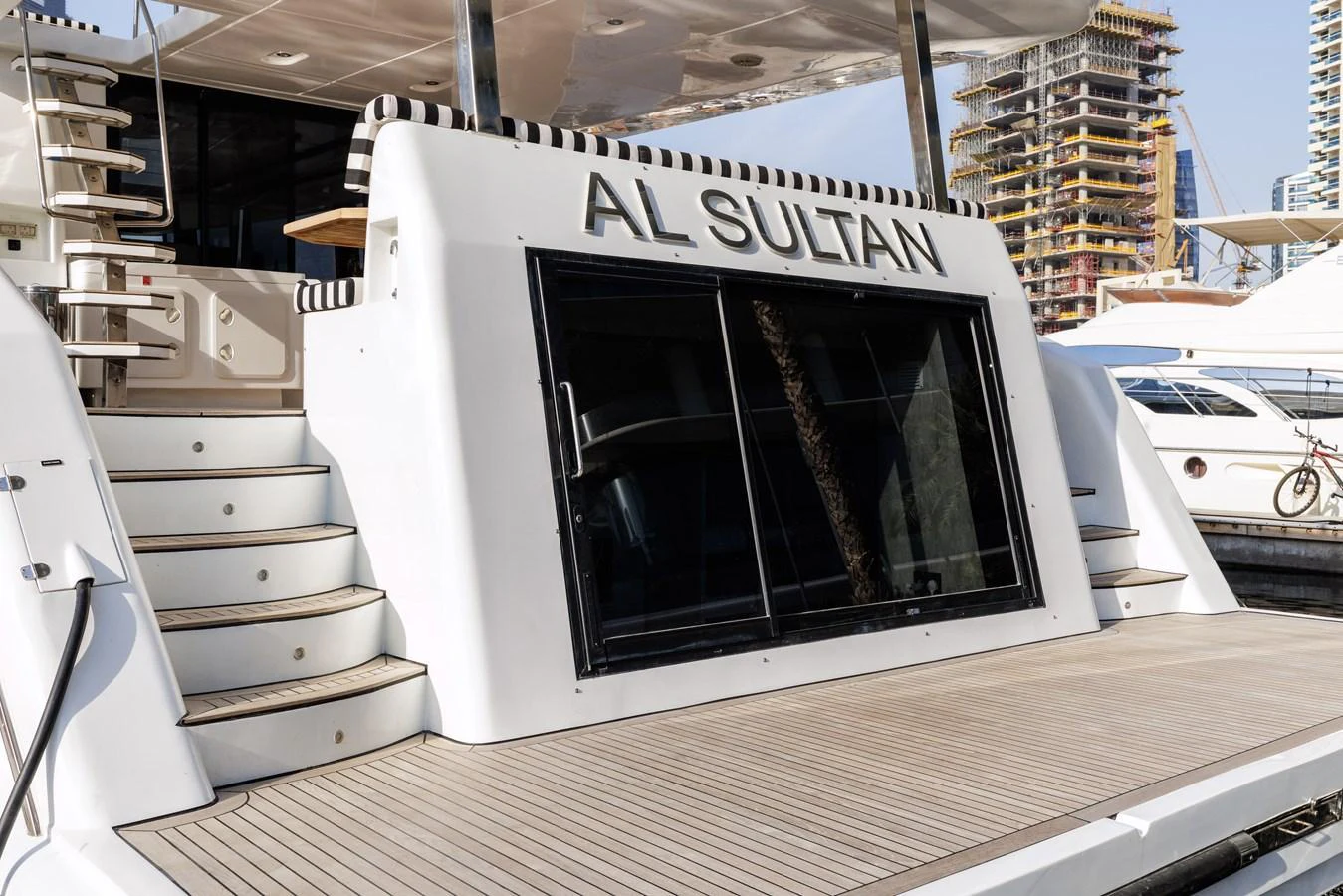 The yacht's aft deck features a spacious and inviting area with elegant steps leading to the upper deck. aboard AL SULTAN Yacht for Sale