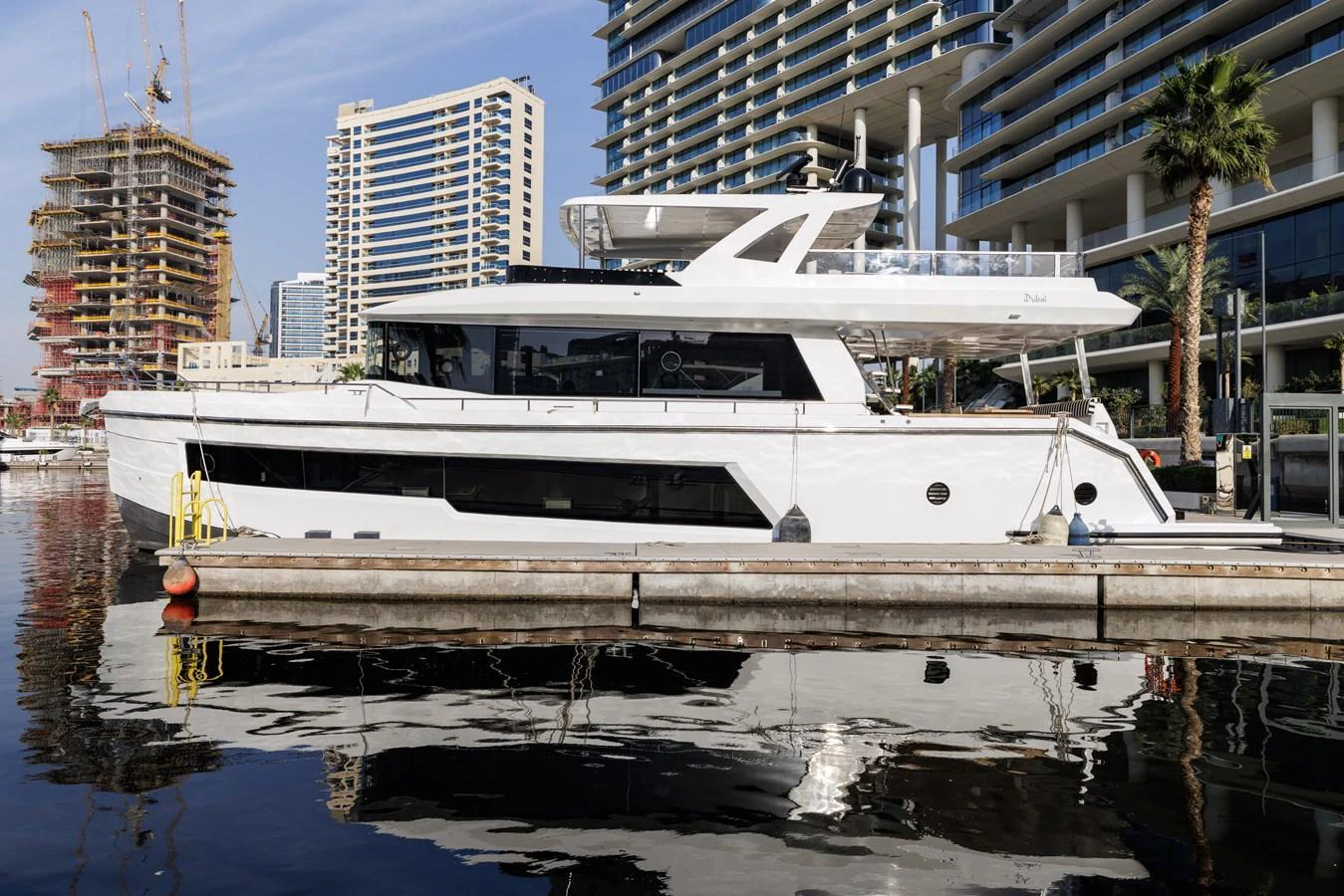 A sleek and modern yacht docked in a vibrant urban marina. aboard AL SULTAN Yacht for Sale
