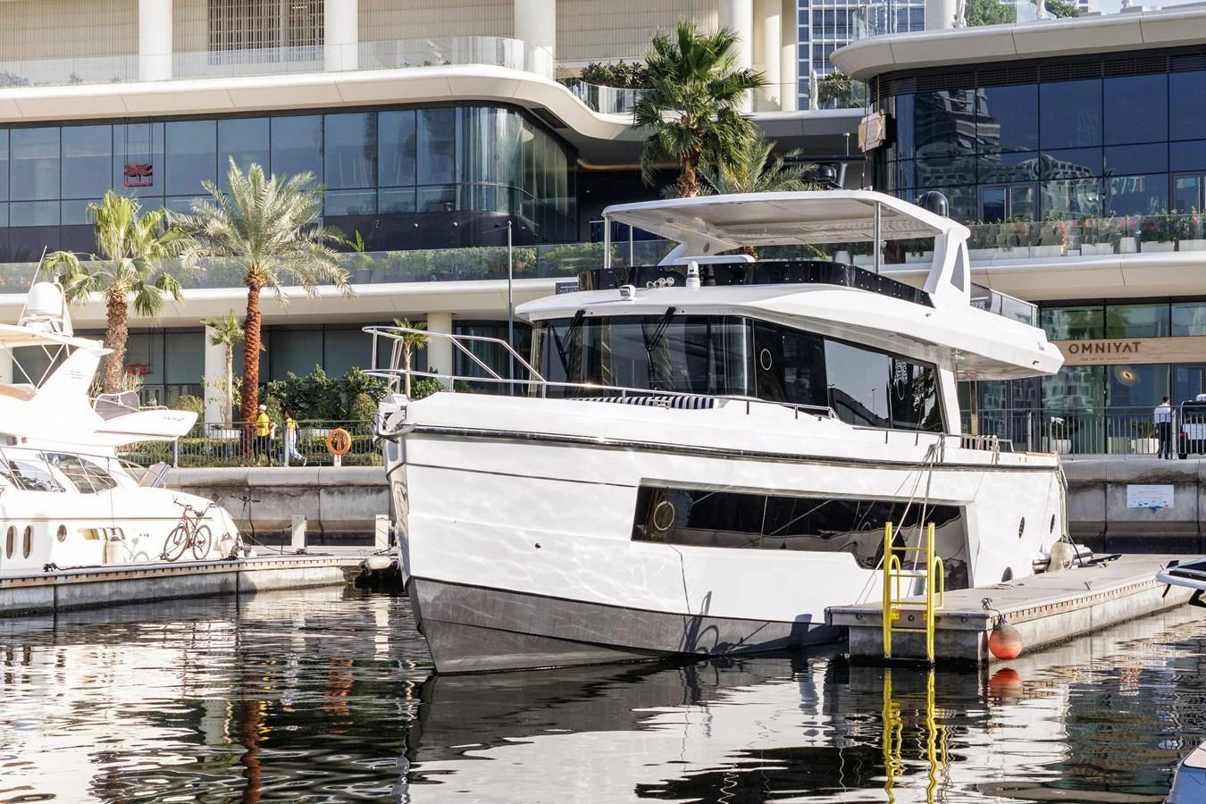 A sleek, modern yacht is docked in a marina, reflecting the luxury waterfront lifestyle. aboard AL SULTAN Yacht for Sale
