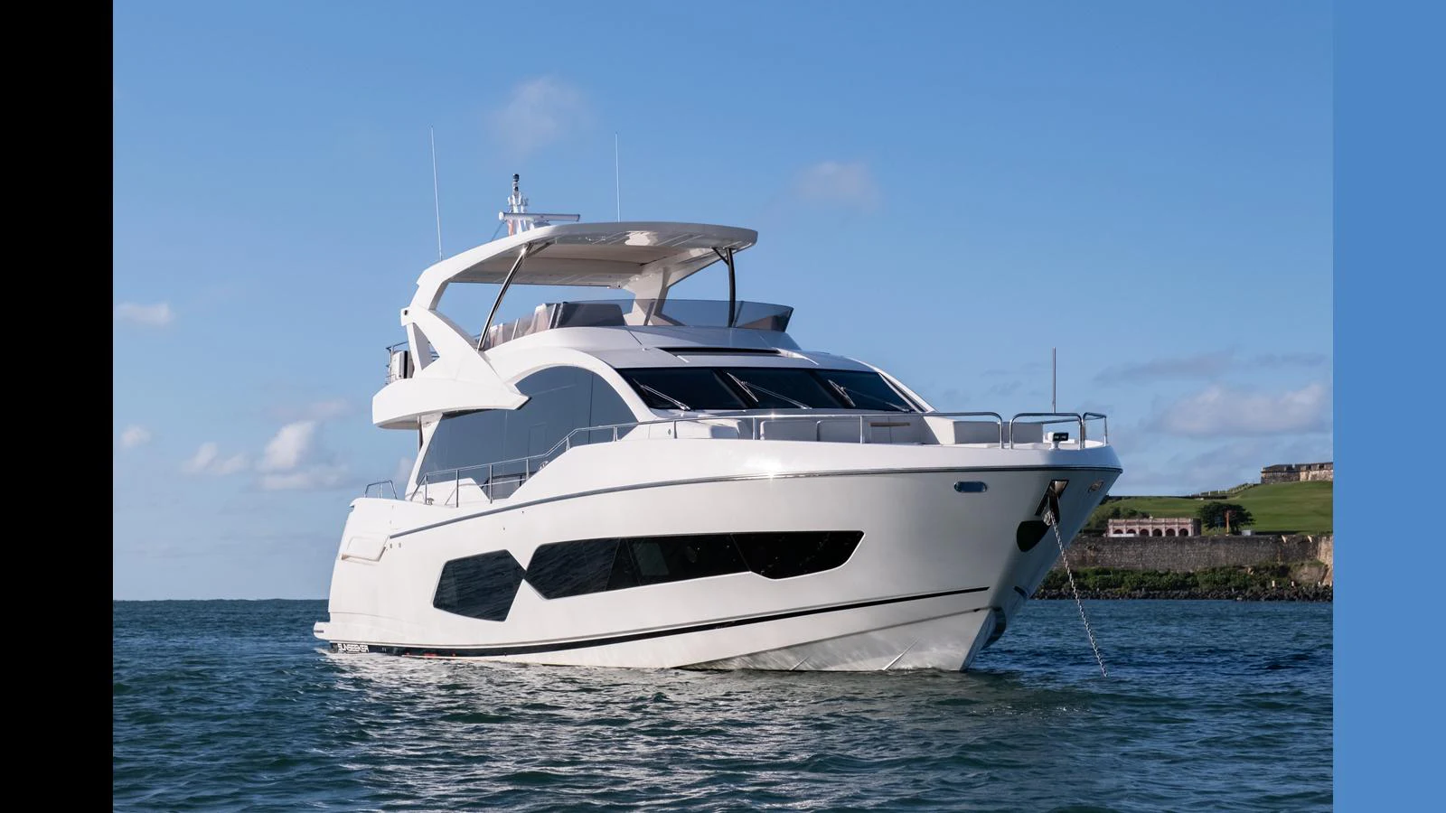 A sleek and modern yacht is anchored on calm waters with a clear blue sky in the background. aboard ONLY 1100 HRS! Yacht for Sale