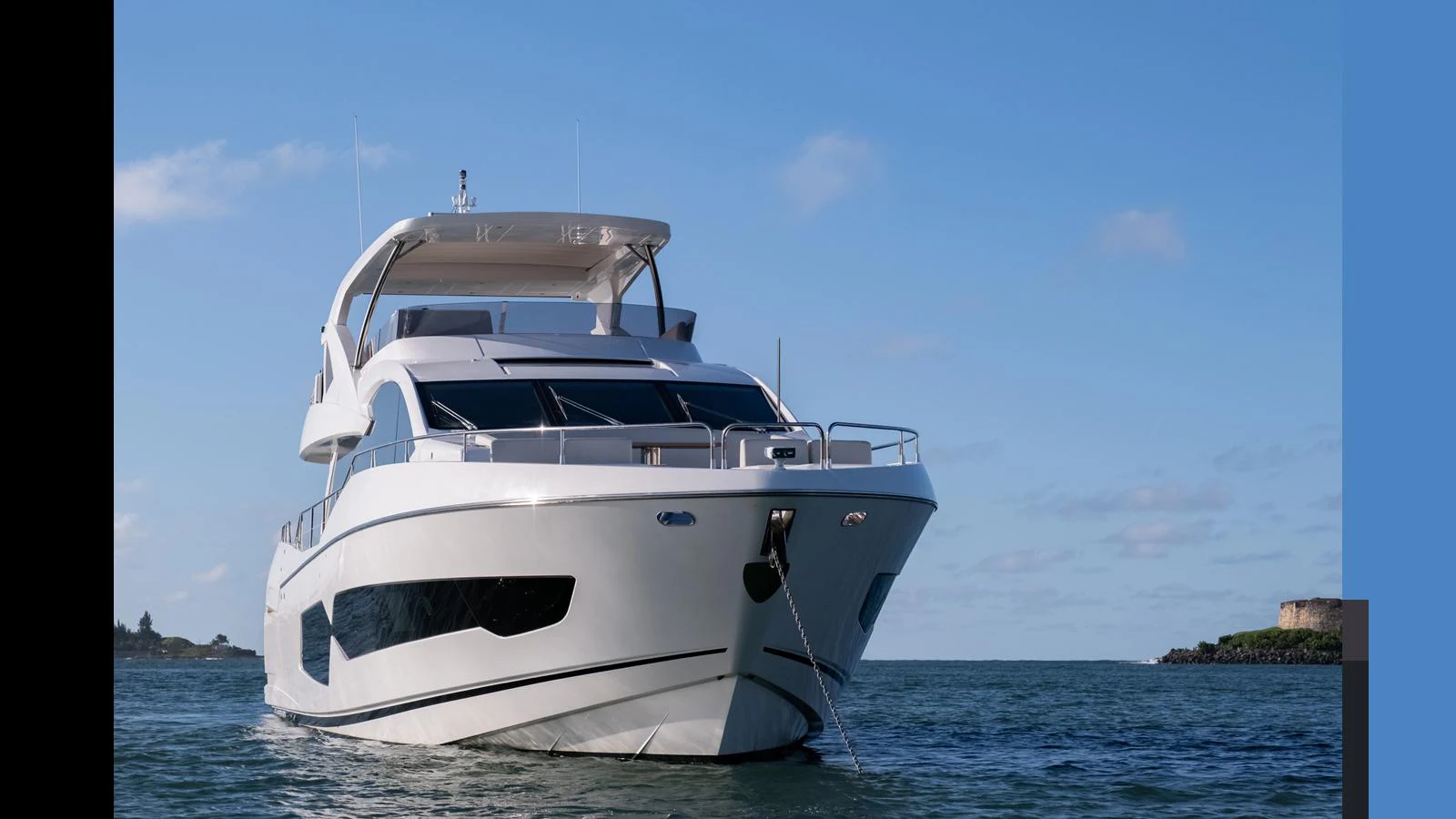 A sleek and modern yacht is anchored in calm waters under a clear blue sky. aboard ONLY 1100 HRS! Yacht for Sale