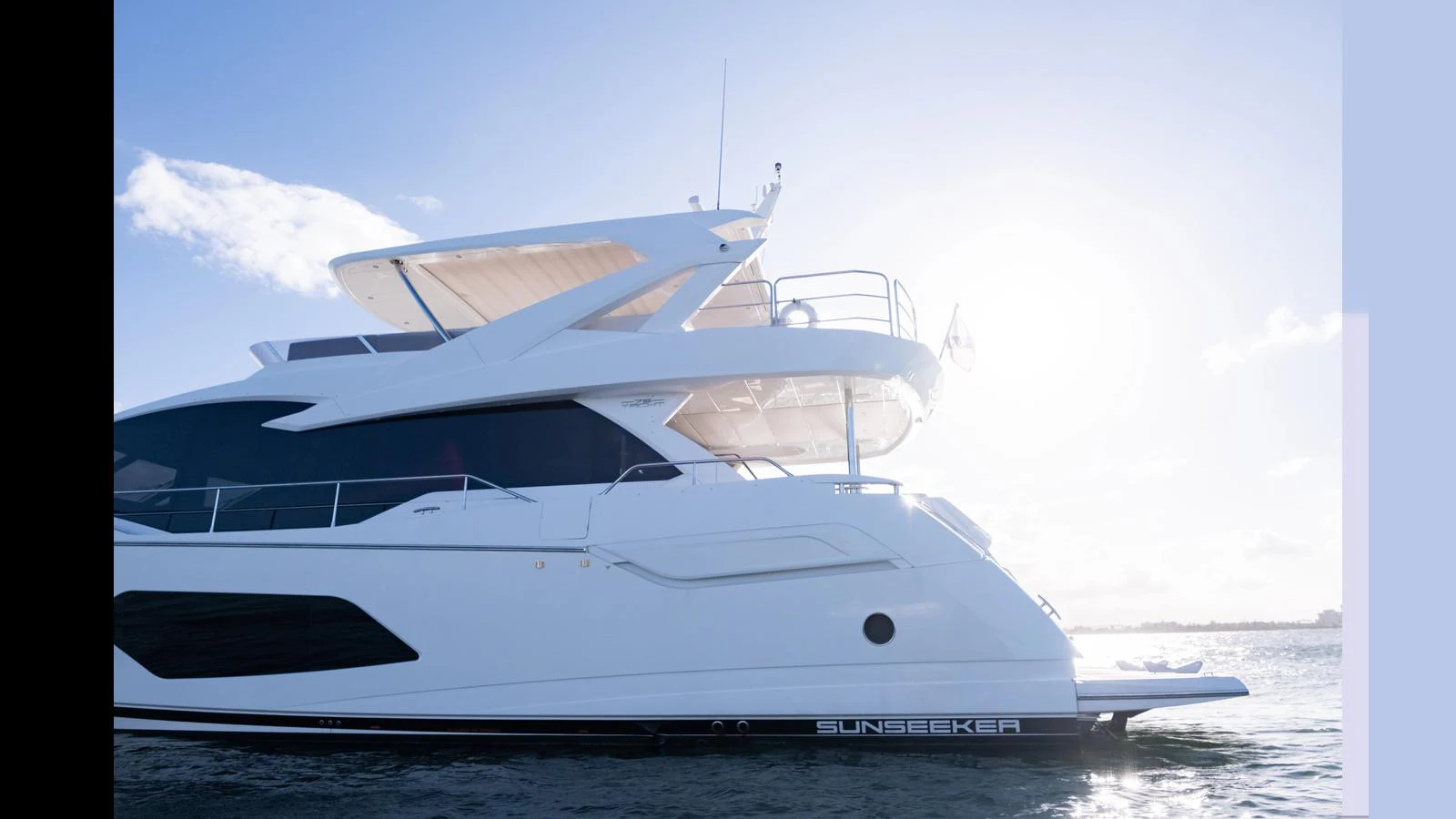 A sleek and modern yacht glides gracefully on the water under a bright sky. aboard ONLY 1100 HRS! Yacht for Sale