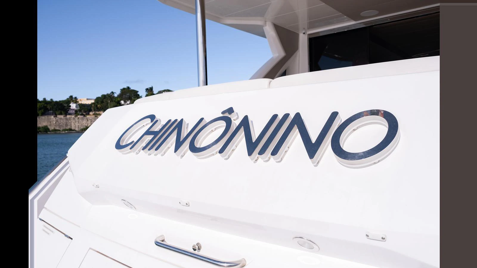 A close-up view of the yacht's nameplate on the stern, showcasing its sleek design. aboard ONLY 1100 HRS! Yacht for Sale