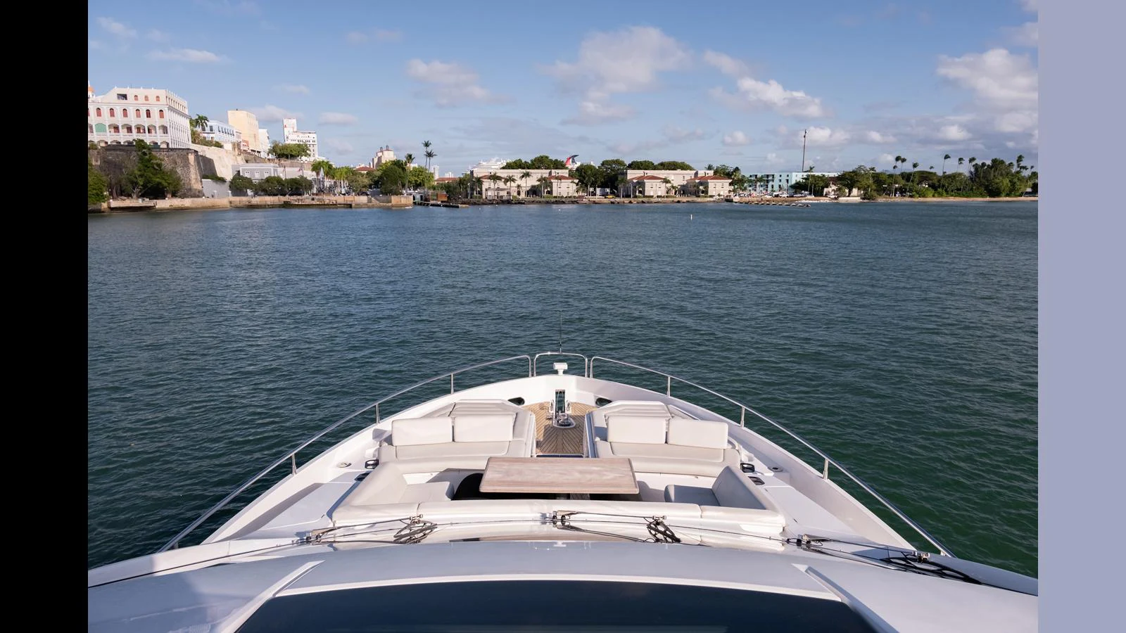 The yacht's bow offers a spacious seating area with a table, perfect for enjoying scenic views while cruising. aboard ONLY 1100 HRS! Yacht for Sale