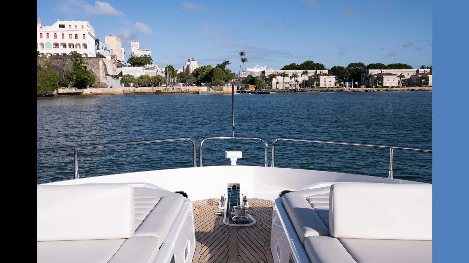 The yacht's bow offers a serene view of the coastline, with comfortable seating and a clear, sunny sky. aboard ONLY 1100 HRS! Yacht for Sale