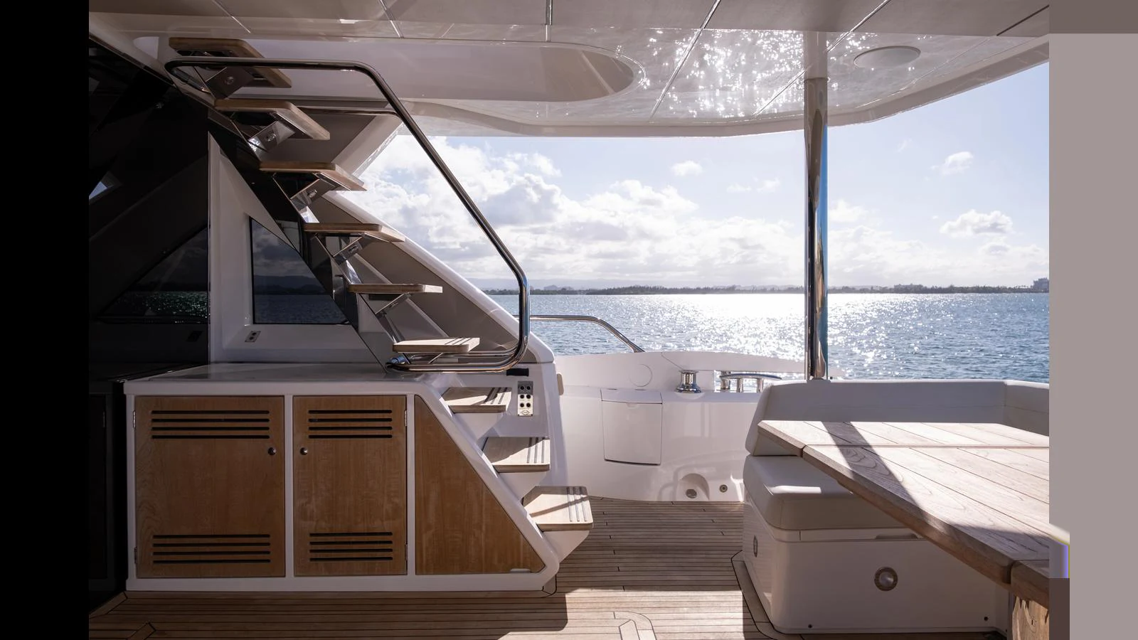 The aft deck offers a serene view of the water, complemented by sleek wooden cabinetry and comfortable seating. aboard ONLY 1100 HRS! Yacht for Sale