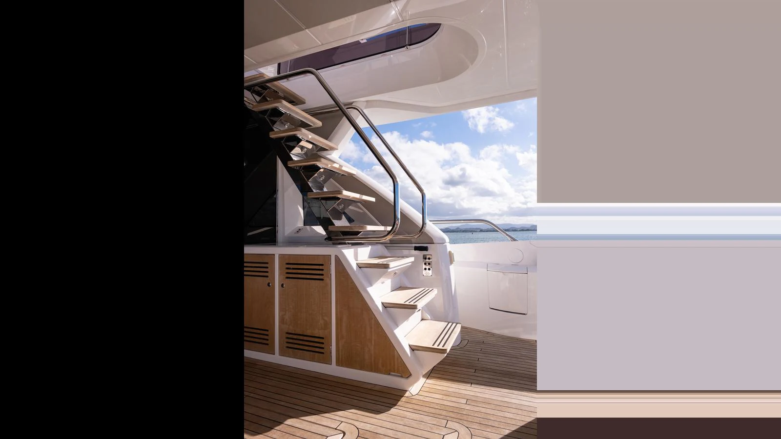 The aft deck features a stylish staircase leading to the upper deck, set against a backdrop of serene waters. aboard ONLY 1100 HRS! Yacht for Sale