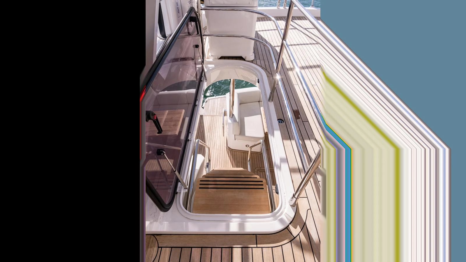A well-crafted stairway with teak steps leads down to the lower deck, showcasing the yacht's elegant design. aboard ONLY 1100 HRS! Yacht for Sale
