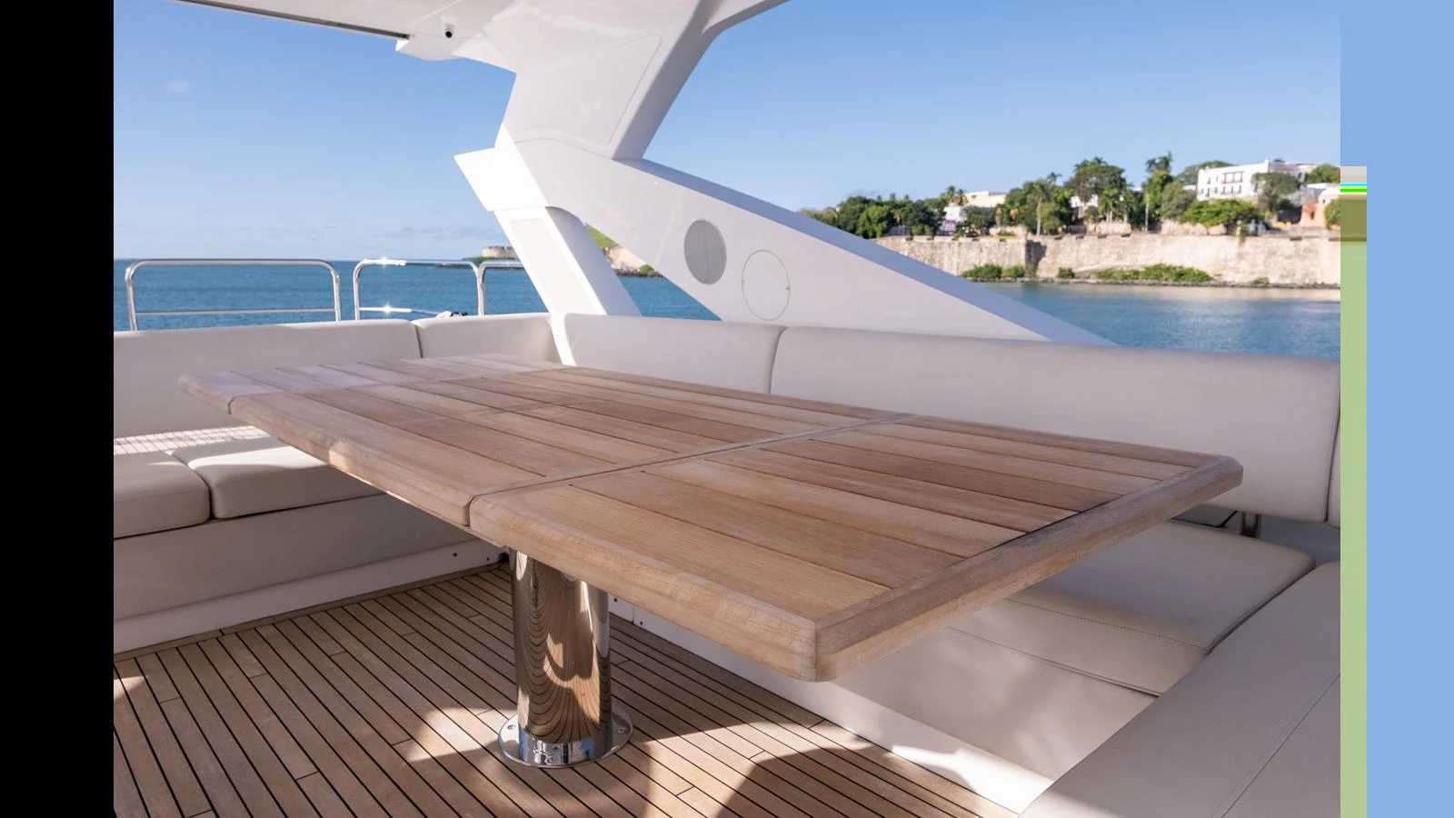 The aft deck features a stylish wooden dining table with comfortable seating, perfect for alfresco dining. aboard ONLY 1100 HRS! Yacht for Sale