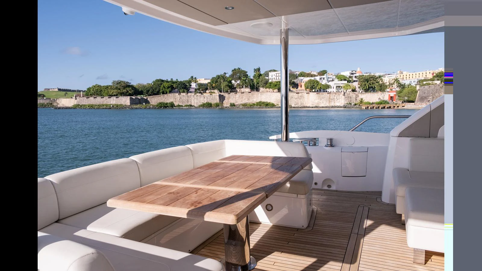 The aft deck features a spacious seating area with a wooden table, perfect for alfresco dining while enjoying the scenic views. aboard ONLY 1100 HRS! Yacht for Sale