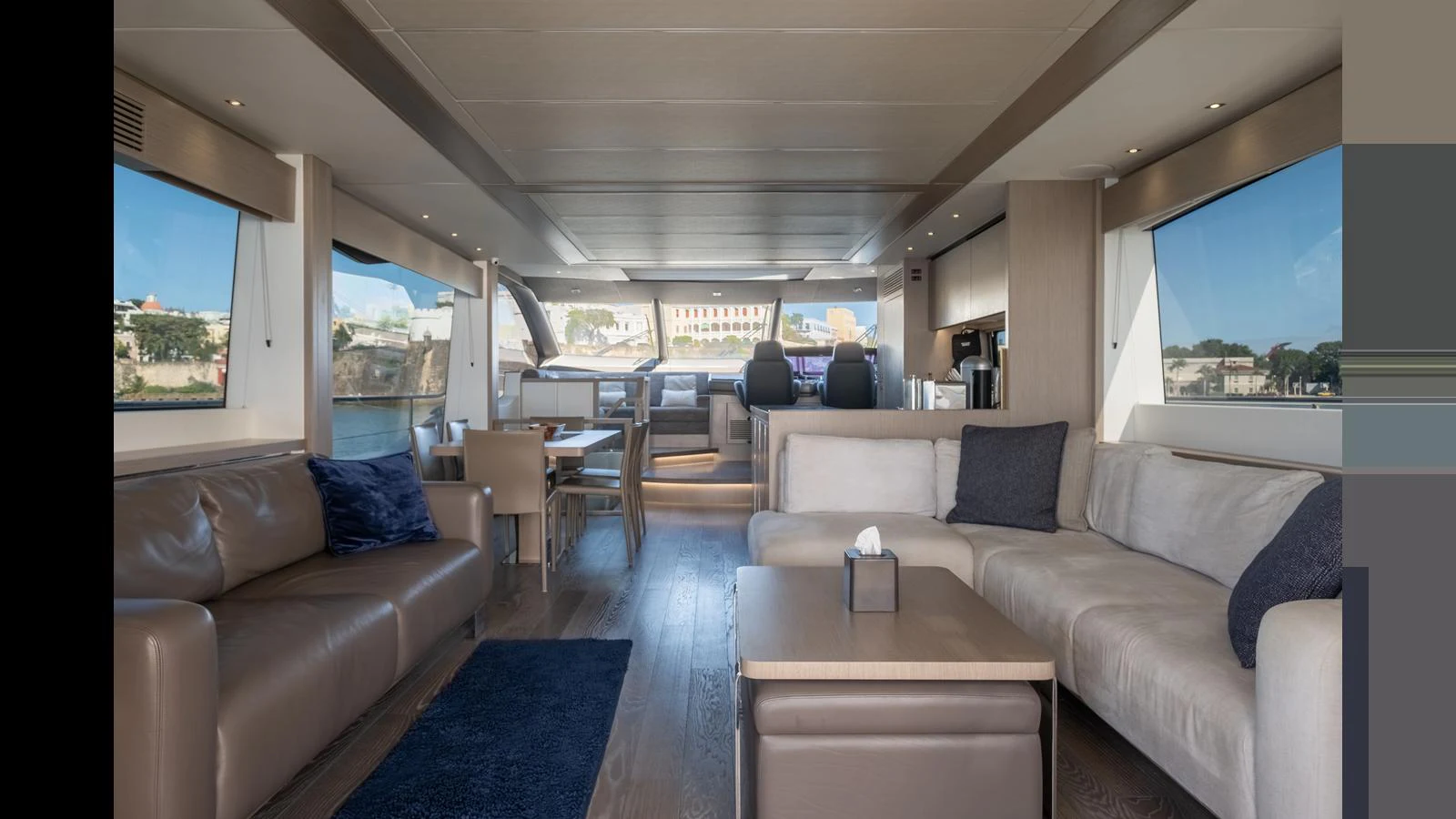 The yacht's salon features luxurious seating with panoramic windows offering stunning views. aboard ONLY 1100 HRS! Yacht for Sale