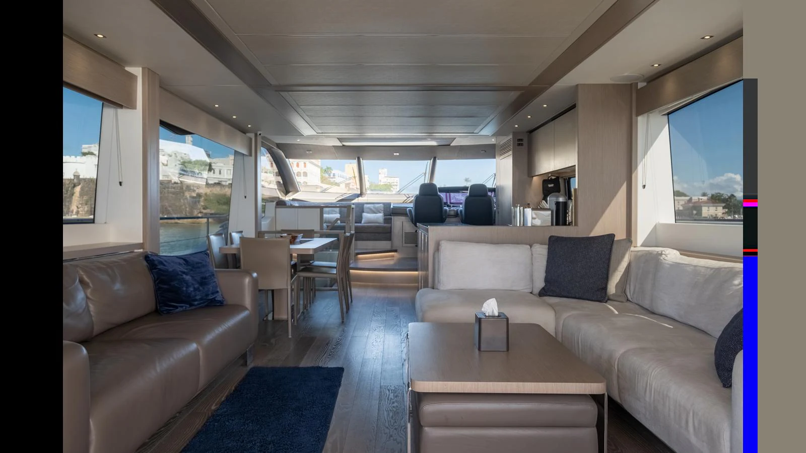 The yacht's salon features a spacious and modern seating area with large windows providing ample natural light. aboard ONLY 1100 HRS! Yacht for Sale