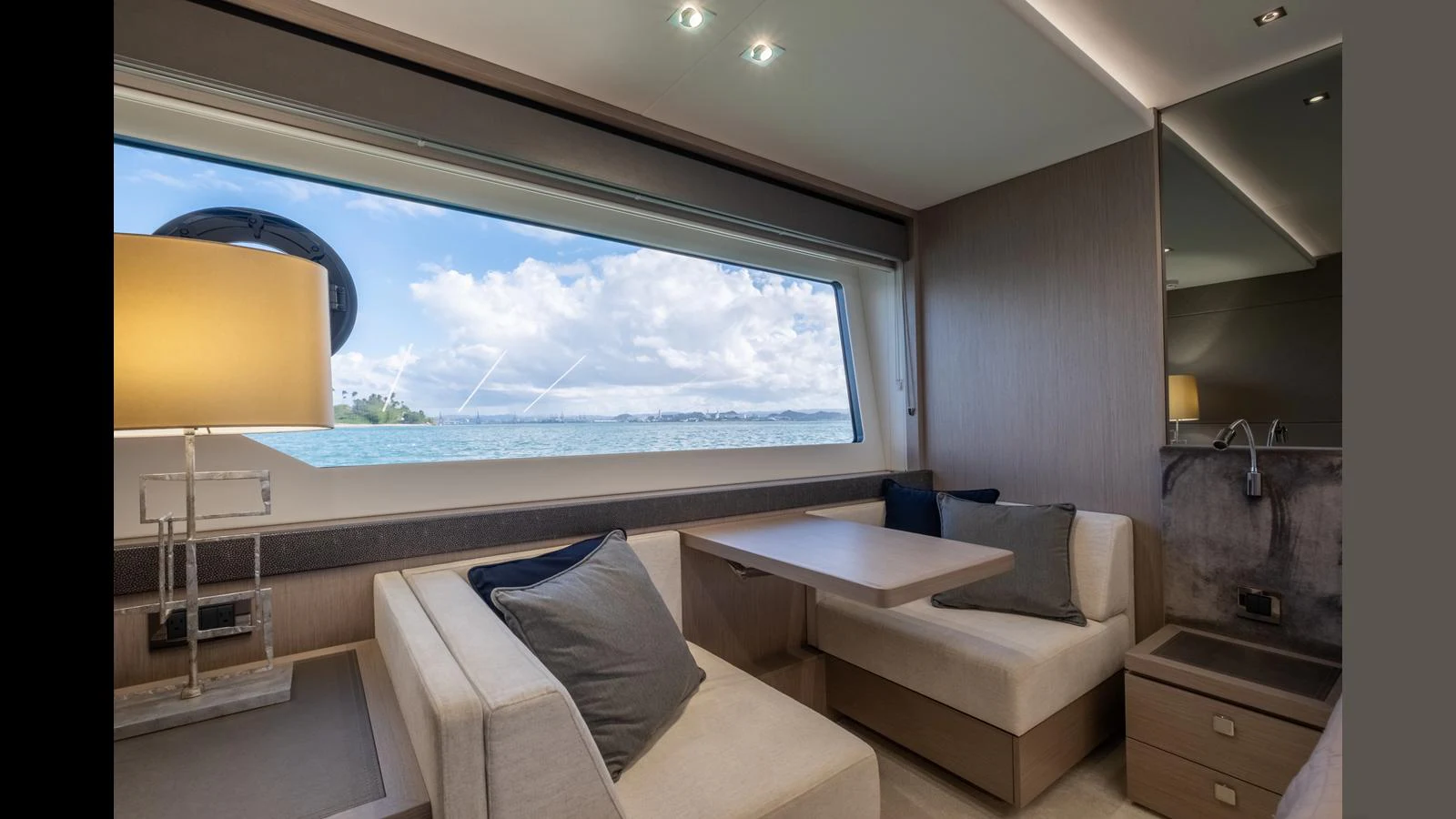 The salon features a cozy seating area with a large window offering stunning sea views. aboard ONLY 1100 HRS! Yacht for Sale