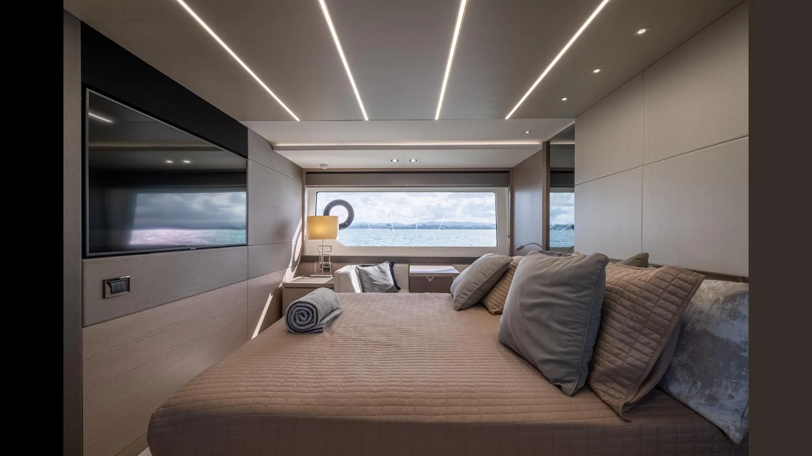 A luxurious stateroom with a large bed, modern lighting, and a scenic window view. aboard ONLY 1100 HRS! Yacht for Sale