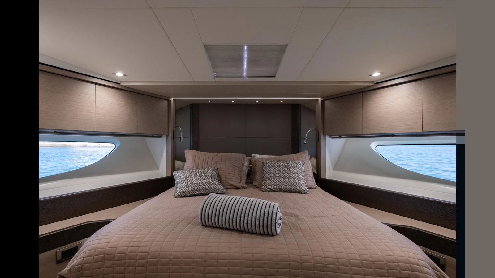 The master stateroom features a luxurious bed with elegant bedding and ample natural light from the side windows. aboard ONLY 1100 HRS! Yacht for Sale