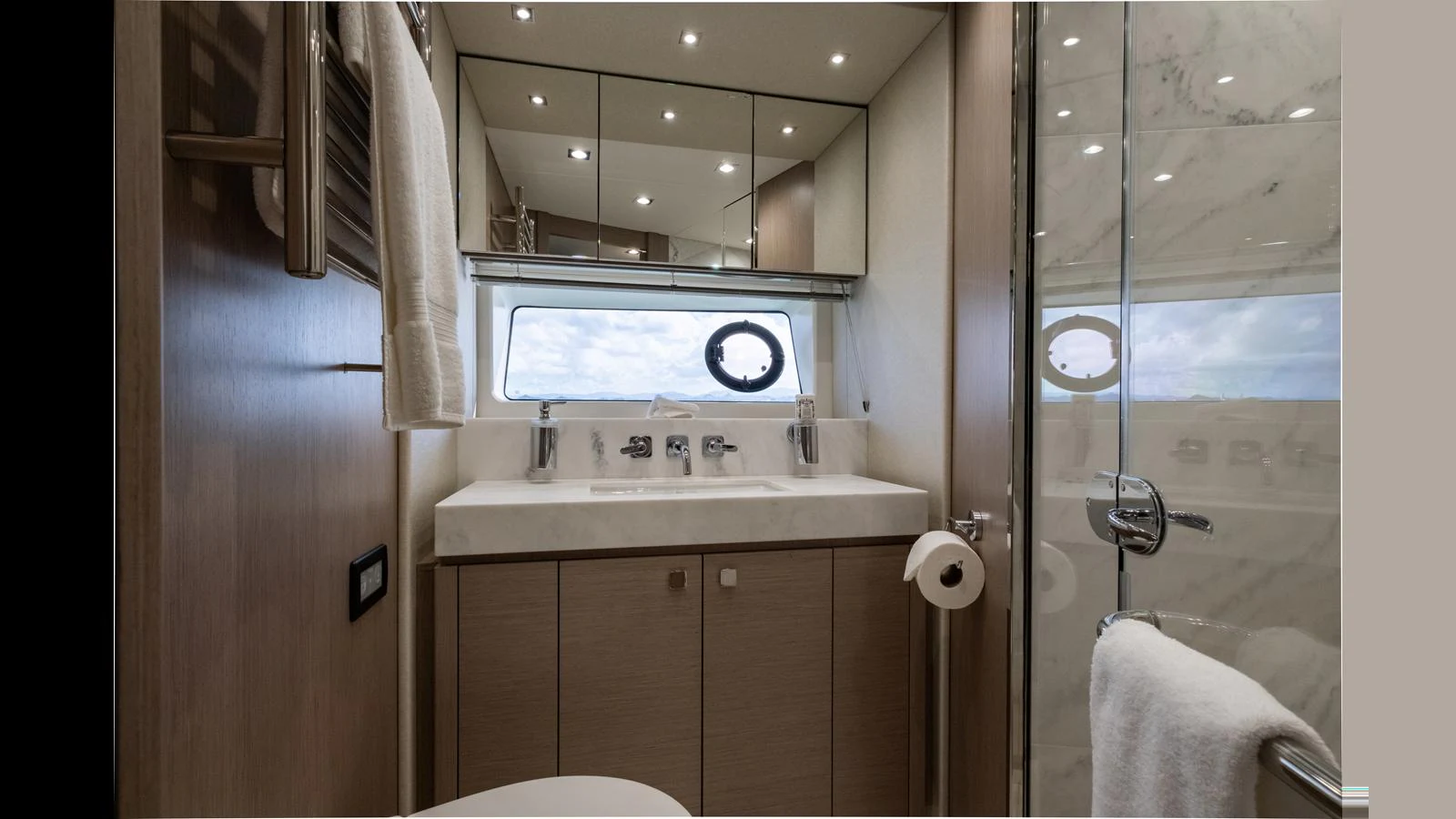 A sleek and modern yacht bathroom with a large mirror and elegant fixtures. aboard ONLY 1100 HRS! Yacht for Sale