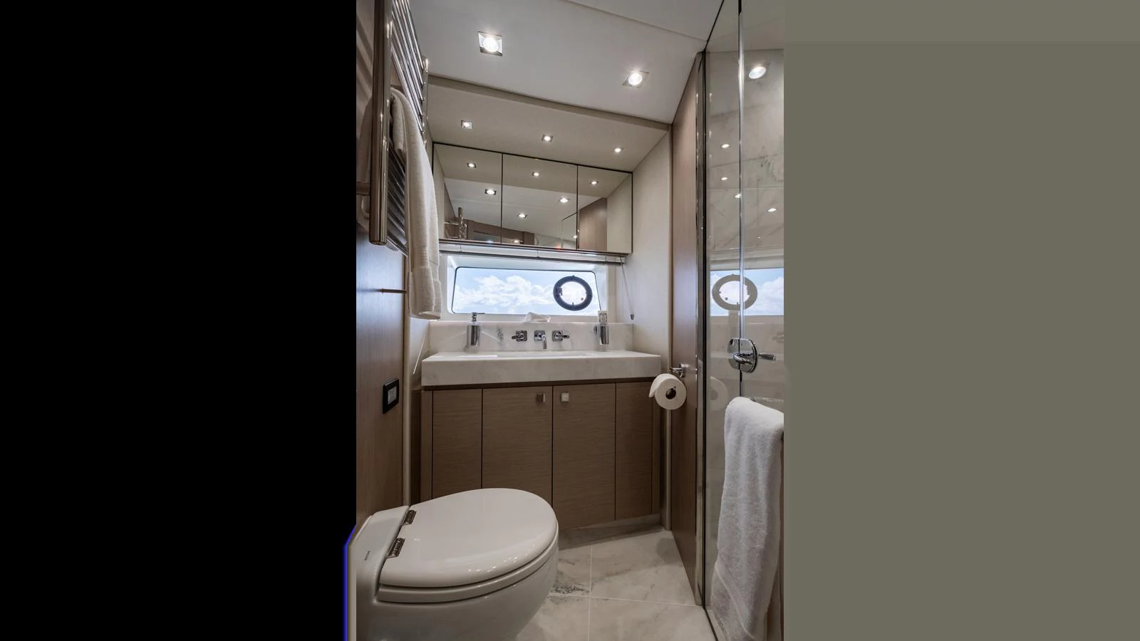 A modern yacht bathroom featuring sleek fixtures and ample lighting. aboard ONLY 1100 HRS! Yacht for Sale