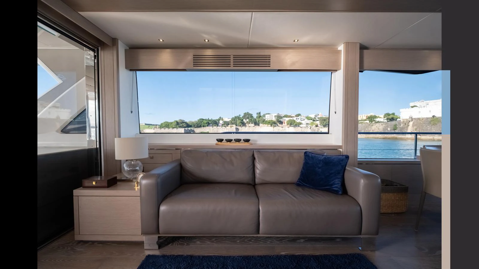 The salon features a comfortable seating area with a large window offering scenic views. aboard ONLY 1100 HRS! Yacht for Sale