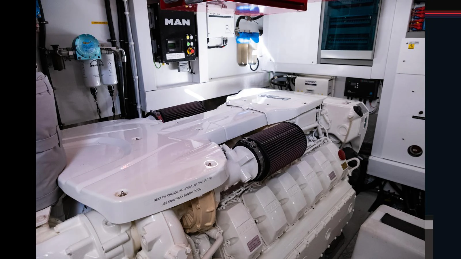 The image showcases a pristine engine room with high-performance machinery. aboard ONLY 1100 HRS! Yacht for Sale