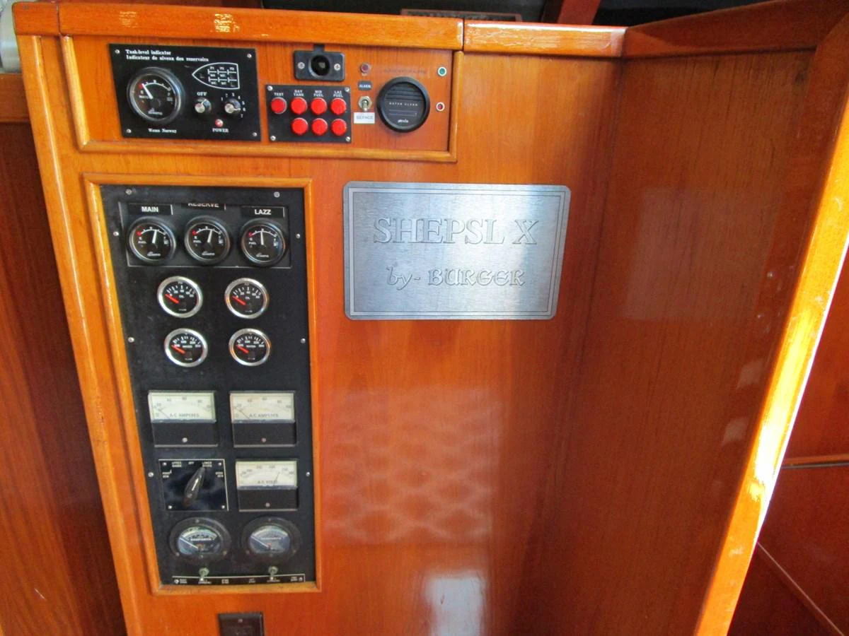 The image showcases a detailed view of the yacht's control panel with various gauges and switches. aboard SHEPSL X Yacht for Sale