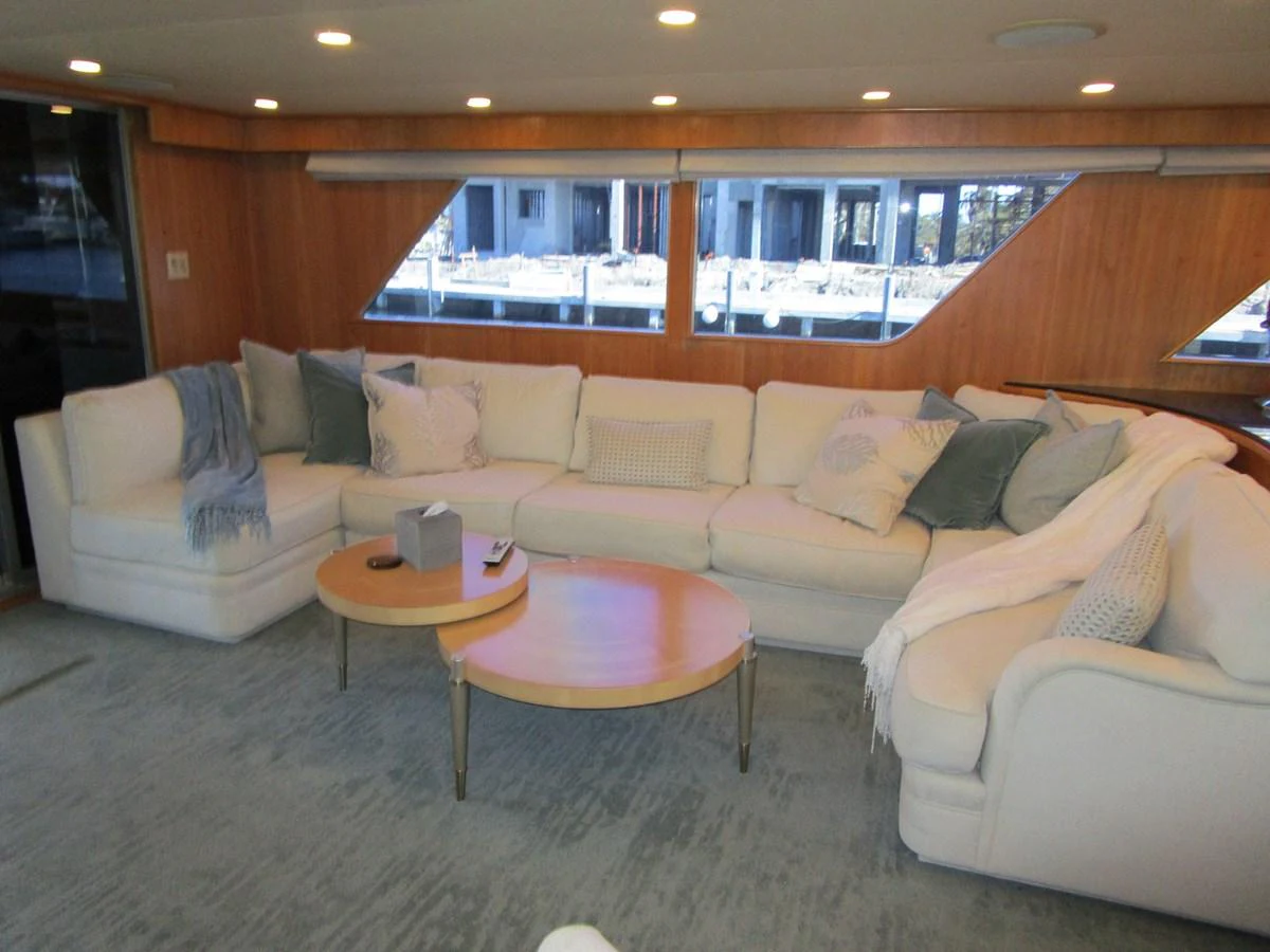 The salon features a spacious and comfortable seating area with large windows providing ample natural light. aboard SHEPSL X Yacht for Sale