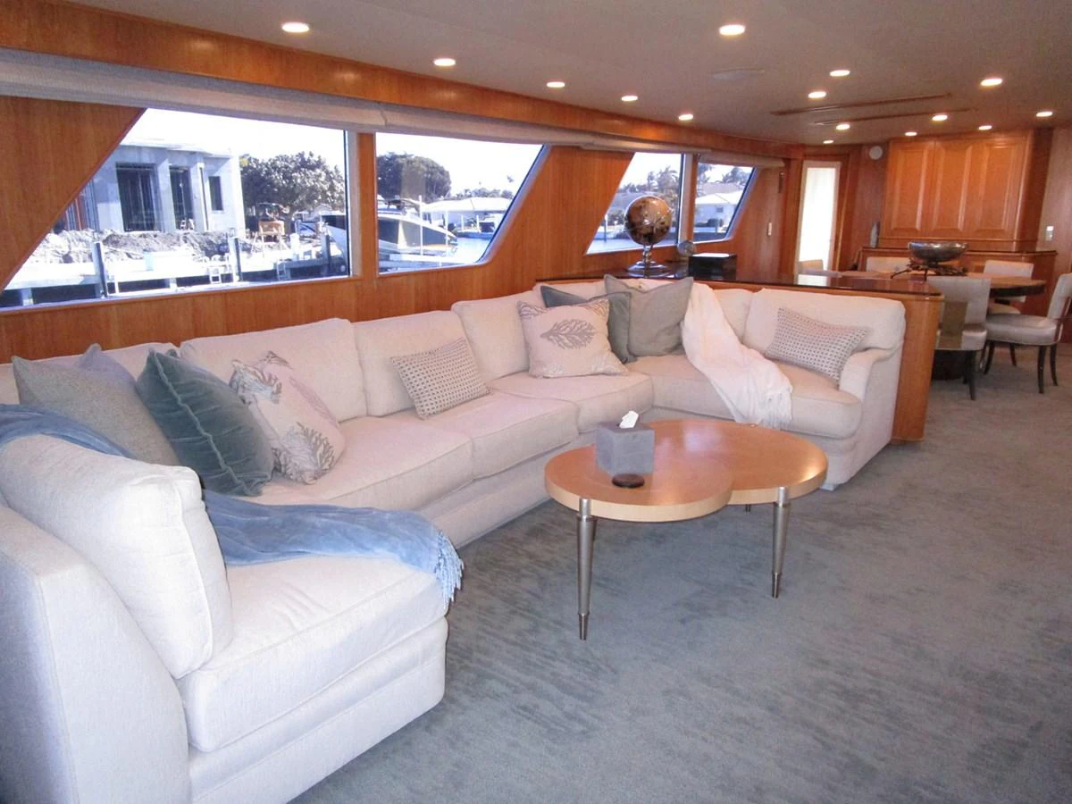The salon features a spacious and comfortable seating area with large windows providing ample natural light. aboard SHEPSL X Yacht for Sale