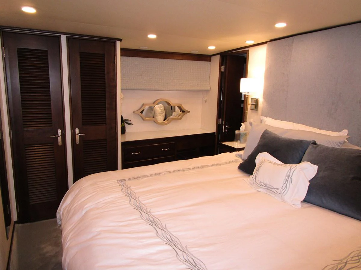 The stateroom features a plush bed with elegant bedding and ample storage space. aboard SHEPSL X Yacht for Sale