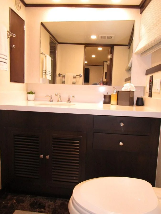 A well-appointed yacht bathroom featuring modern fixtures and ample storage. aboard SHEPSL X Yacht for Sale