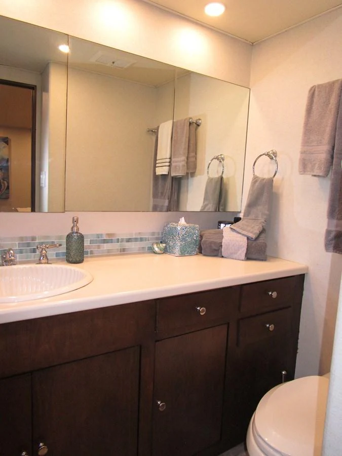 The yacht's bathroom features a sleek vanity with ample storage and modern fixtures. aboard SHEPSL X Yacht for Sale