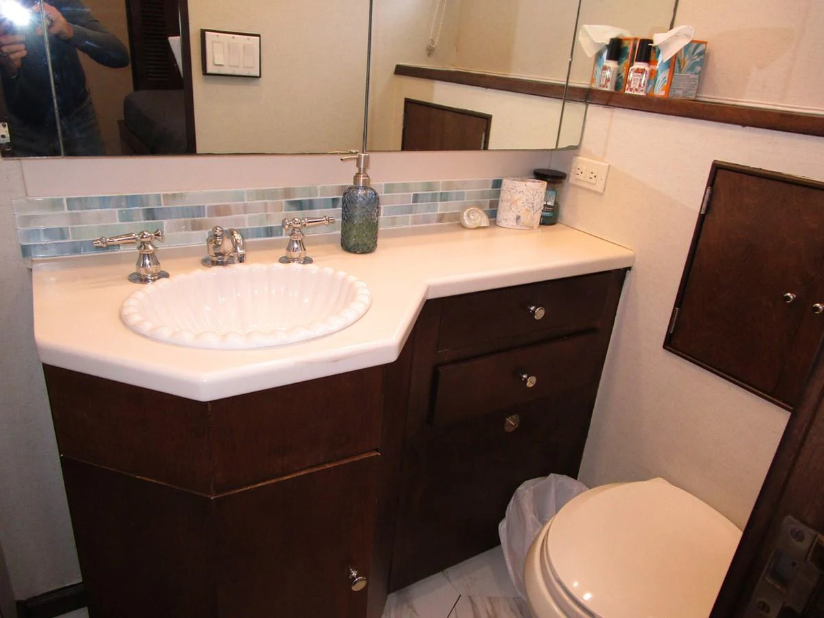 The yacht's bathroom features a stylish sink, modern fixtures, and a compact layout. aboard SHEPSL X Yacht for Sale