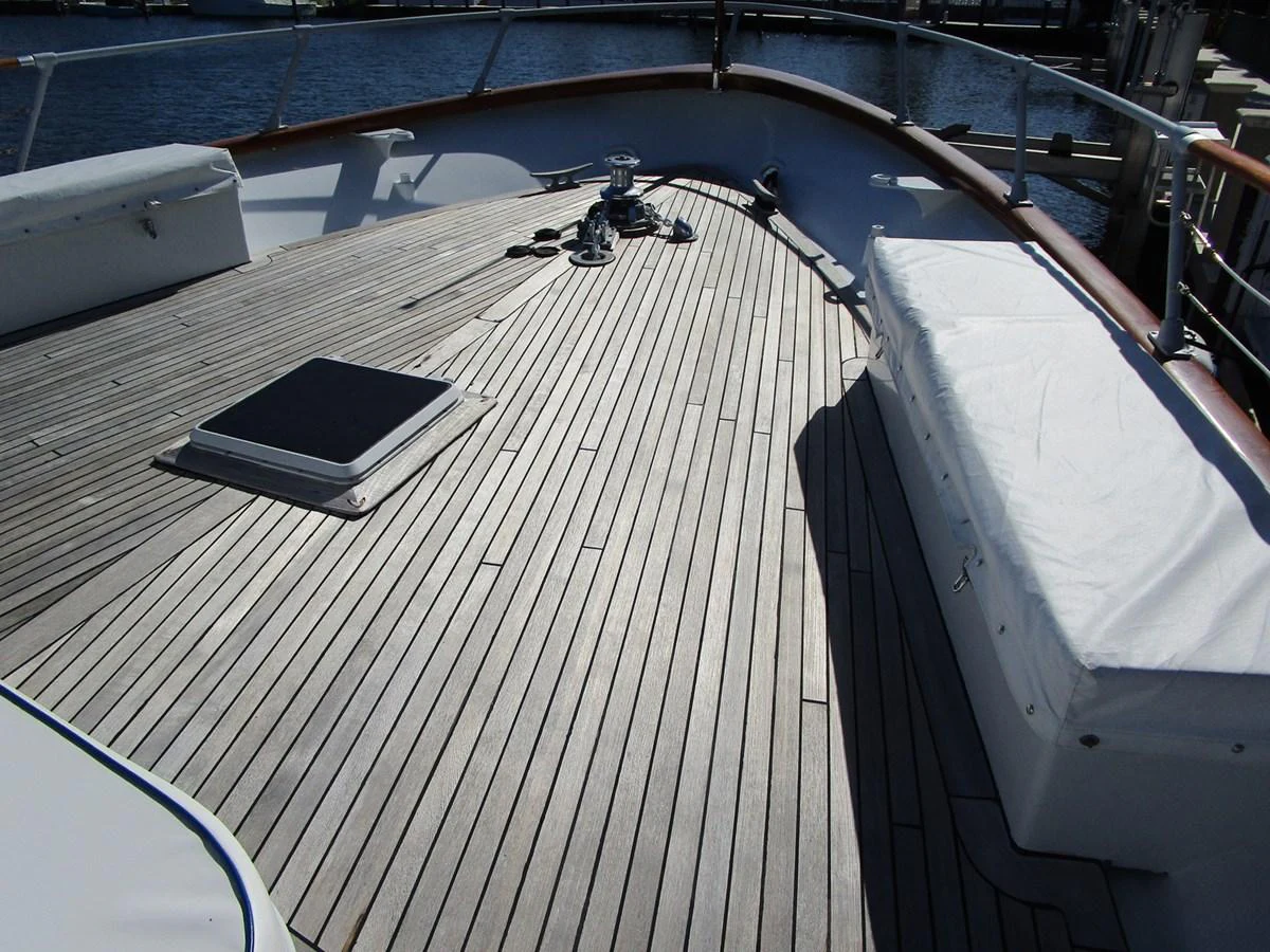 The foredeck features a spacious teak deck with a covered seating area and a hatch. aboard SHEPSL X Yacht for Sale