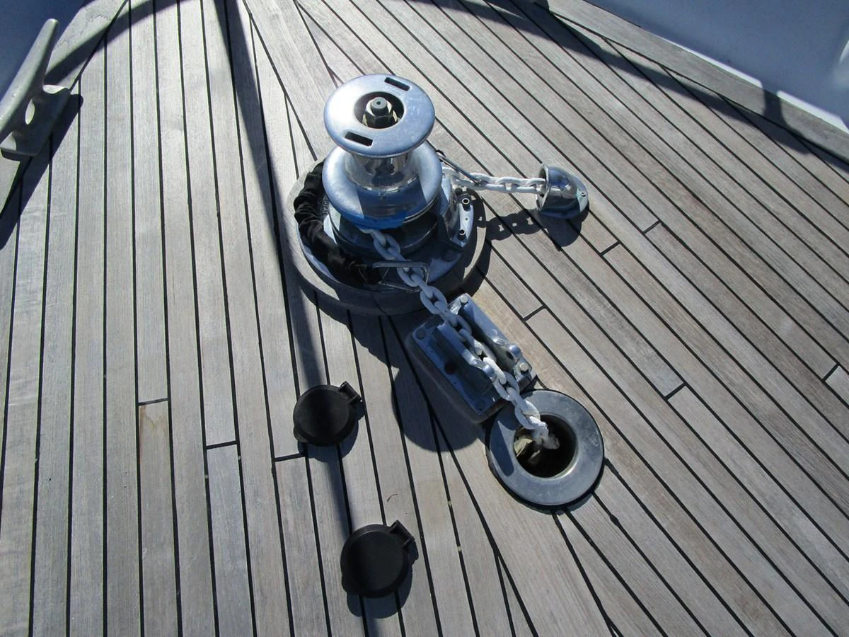 A close-up view of the yacht's anchor windlass and chain on the deck. aboard SHEPSL X Yacht for Sale