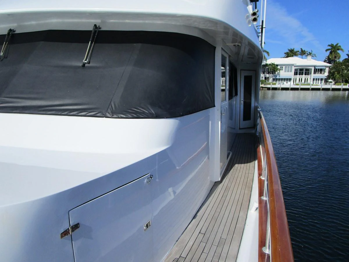 The yacht's sleek exterior features a polished deck and modern design, set against a serene waterfront backdrop. aboard SHEPSL X Yacht for Sale