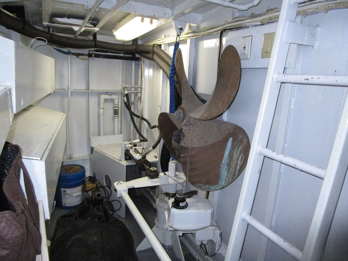 The image showcases a technical area of the yacht, featuring a large propeller and various mechanical components. aboard SHEPSL X Yacht for Sale