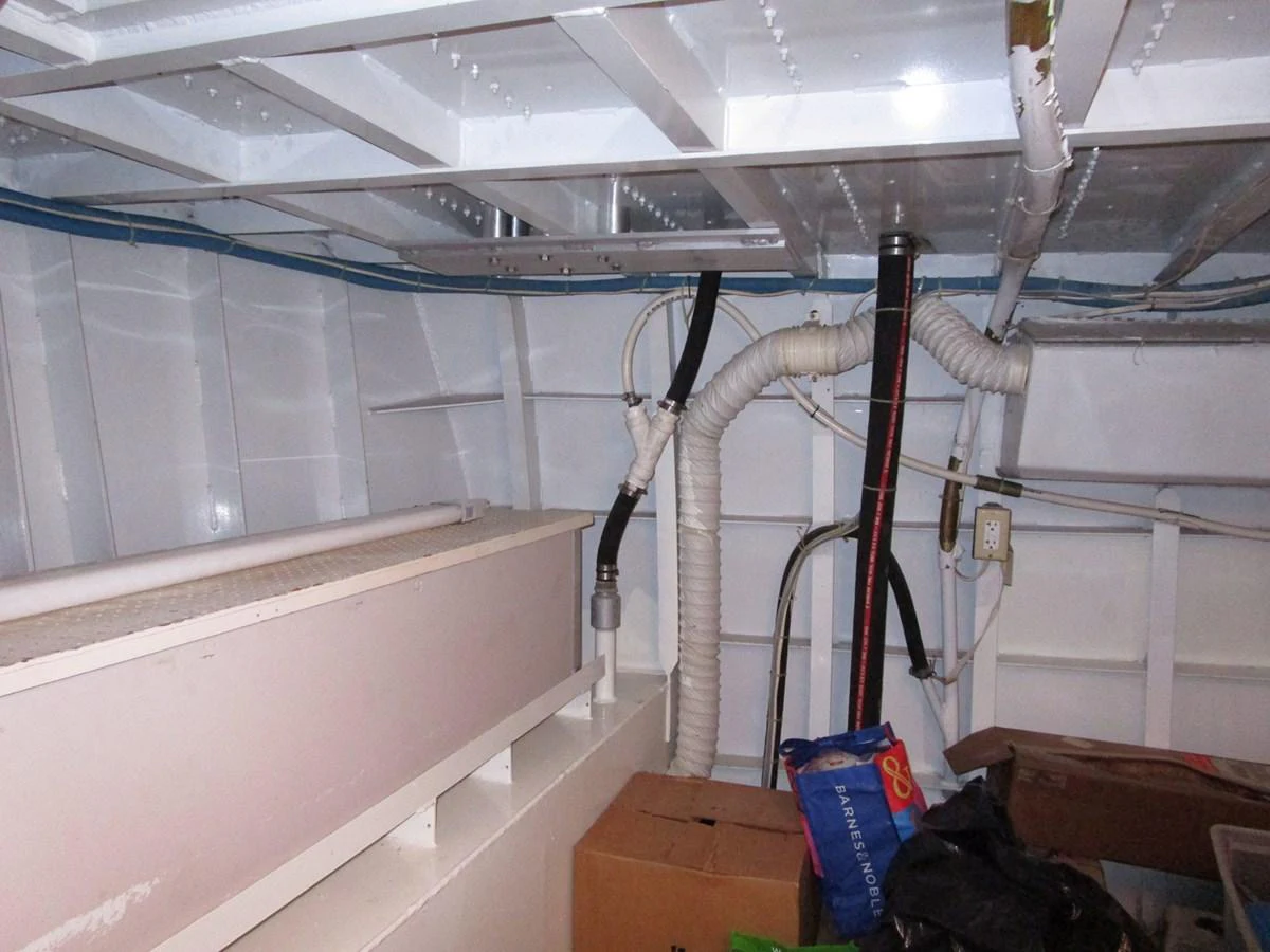 A view of the yacht's utility or storage area, showcasing various pipes and equipment. aboard SHEPSL X Yacht for Sale