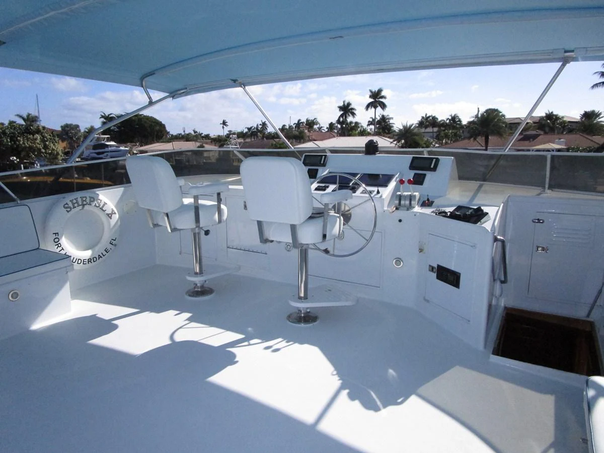 The flybridge offers a spacious and well-equipped helm area with comfortable seating and panoramic views. aboard SHEPSL X Yacht for Sale