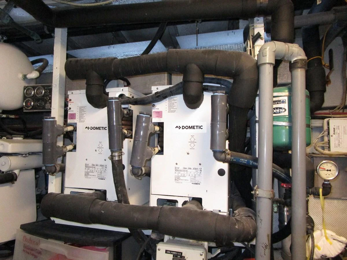 The image showcases the technical equipment and machinery within the yacht's engine room. aboard SHEPSL X Yacht for Sale