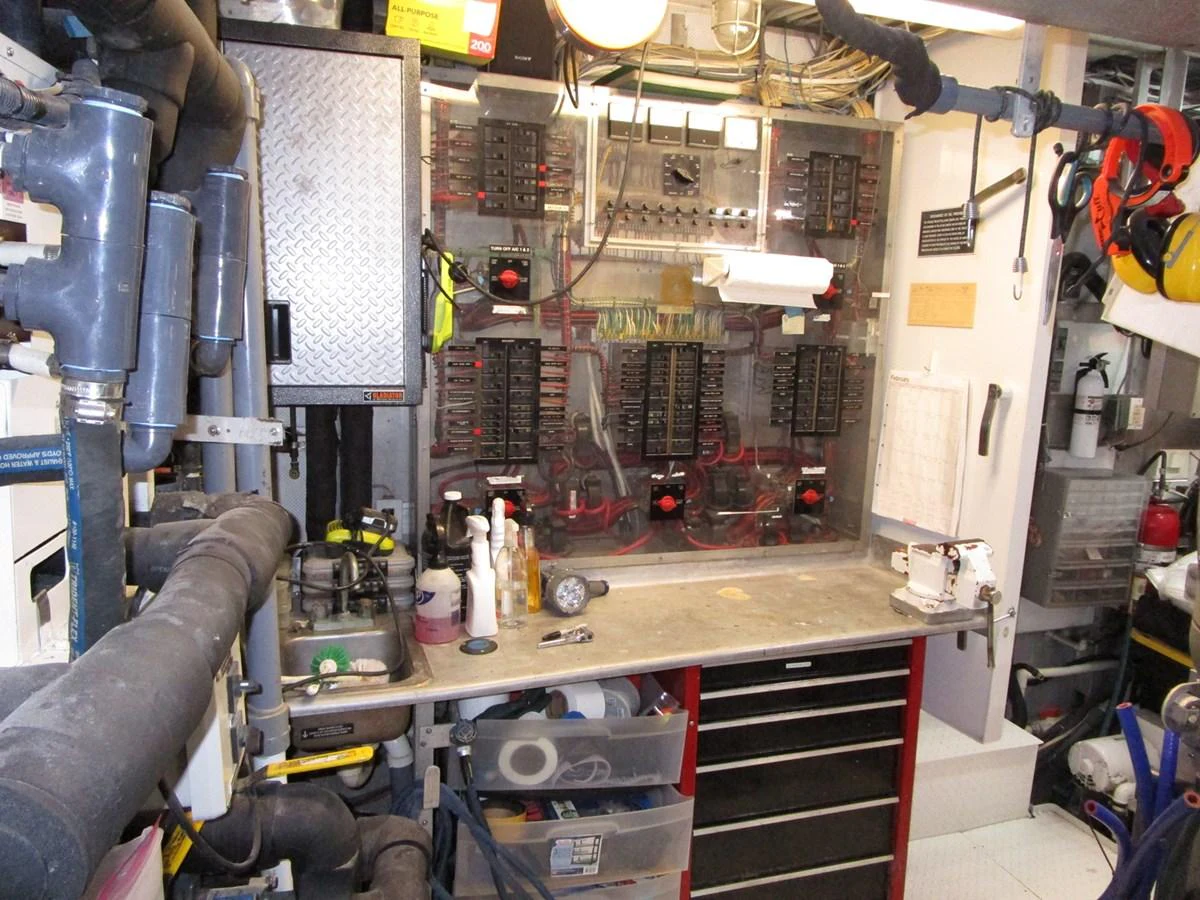 The yacht's engine room is equipped with a well-organized control panel and various tools for maintenance. aboard SHEPSL X Yacht for Sale