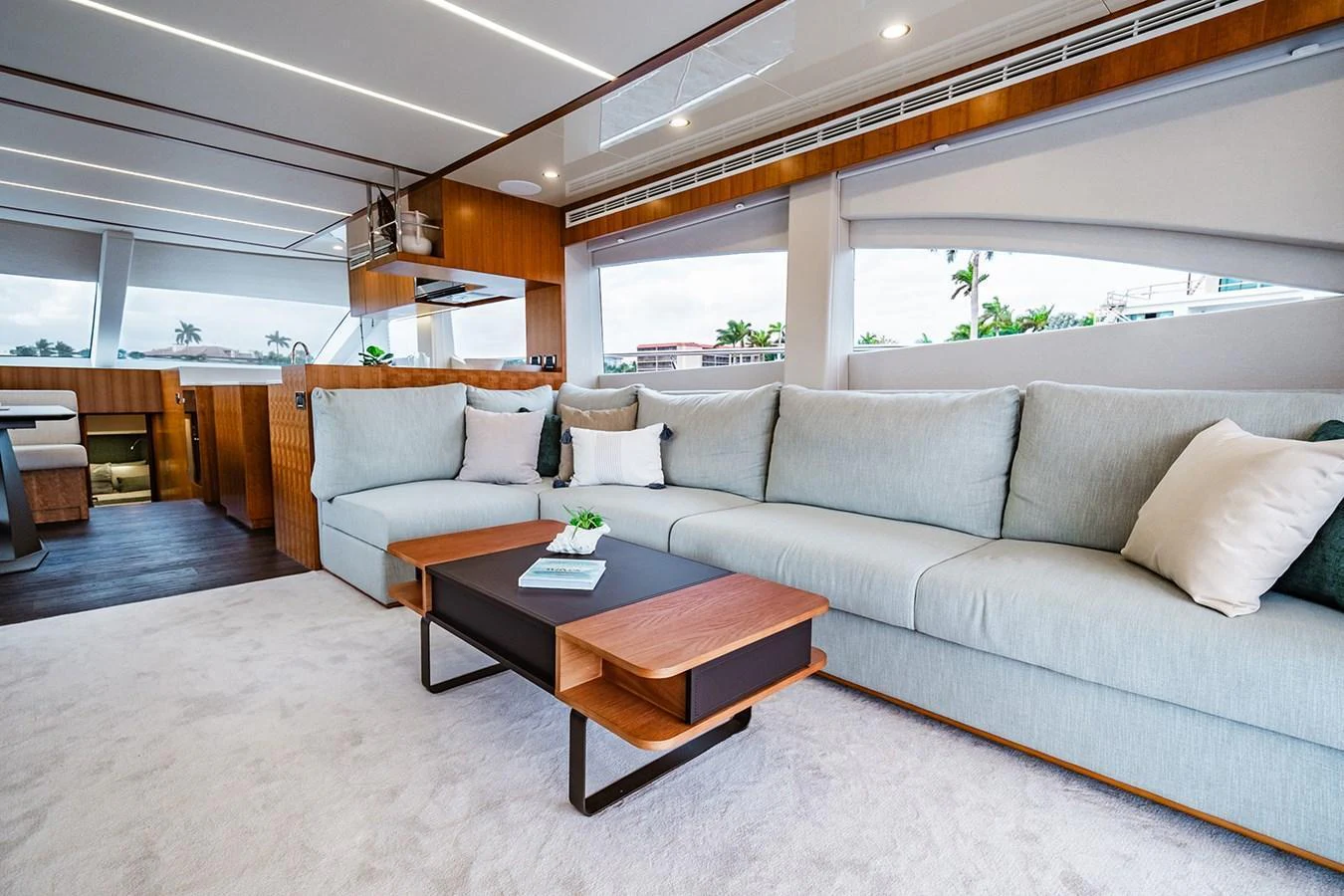 The salon features a spacious and modern seating area with large windows providing ample natural light. aboard INDIGO Yacht for Sale