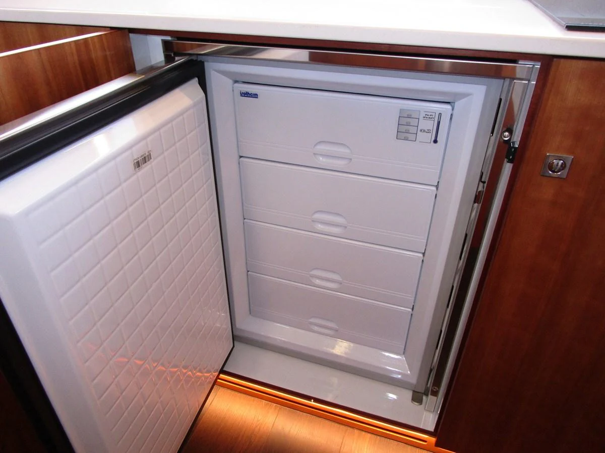 A close-up view of a built-in freezer in the yacht's galley, showcasing its storage capacity. aboard INDIGO Yacht for Sale