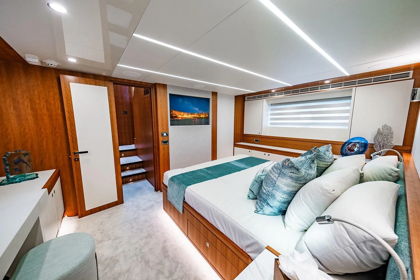 A luxurious stateroom featuring a large bed, modern lighting, and elegant decor. aboard INDIGO Yacht for Sale