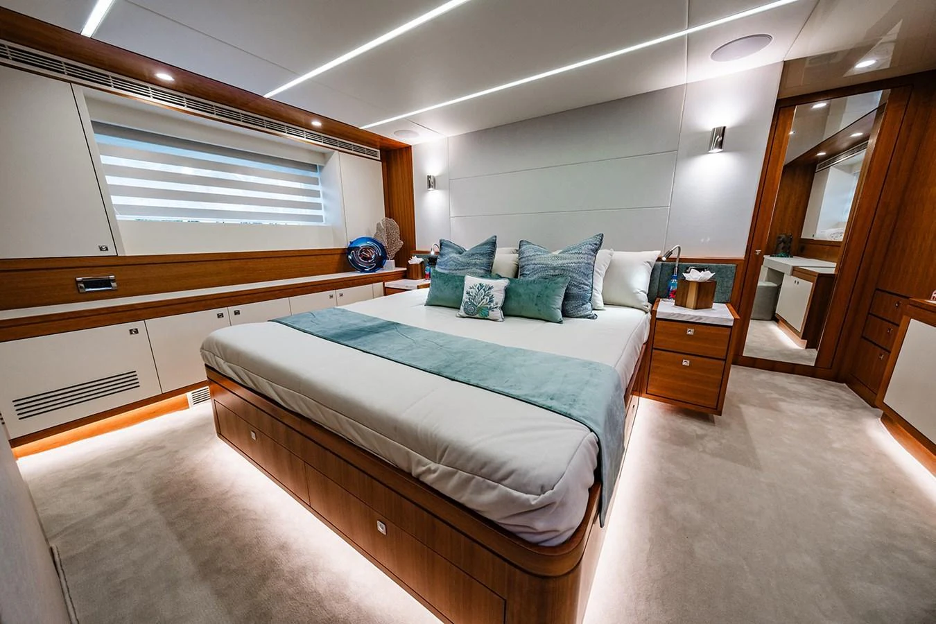 A luxurious stateroom featuring a large bed with elegant bedding and modern lighting. aboard INDIGO Yacht for Sale