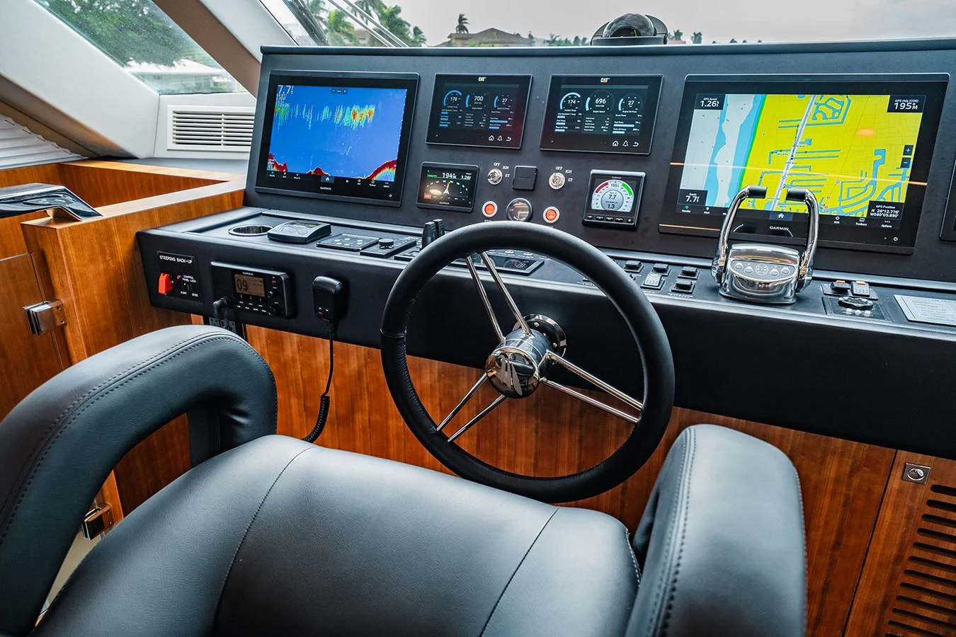 The helm station features advanced navigation equipment and a comfortable captain's chair. aboard INDIGO Yacht for Sale